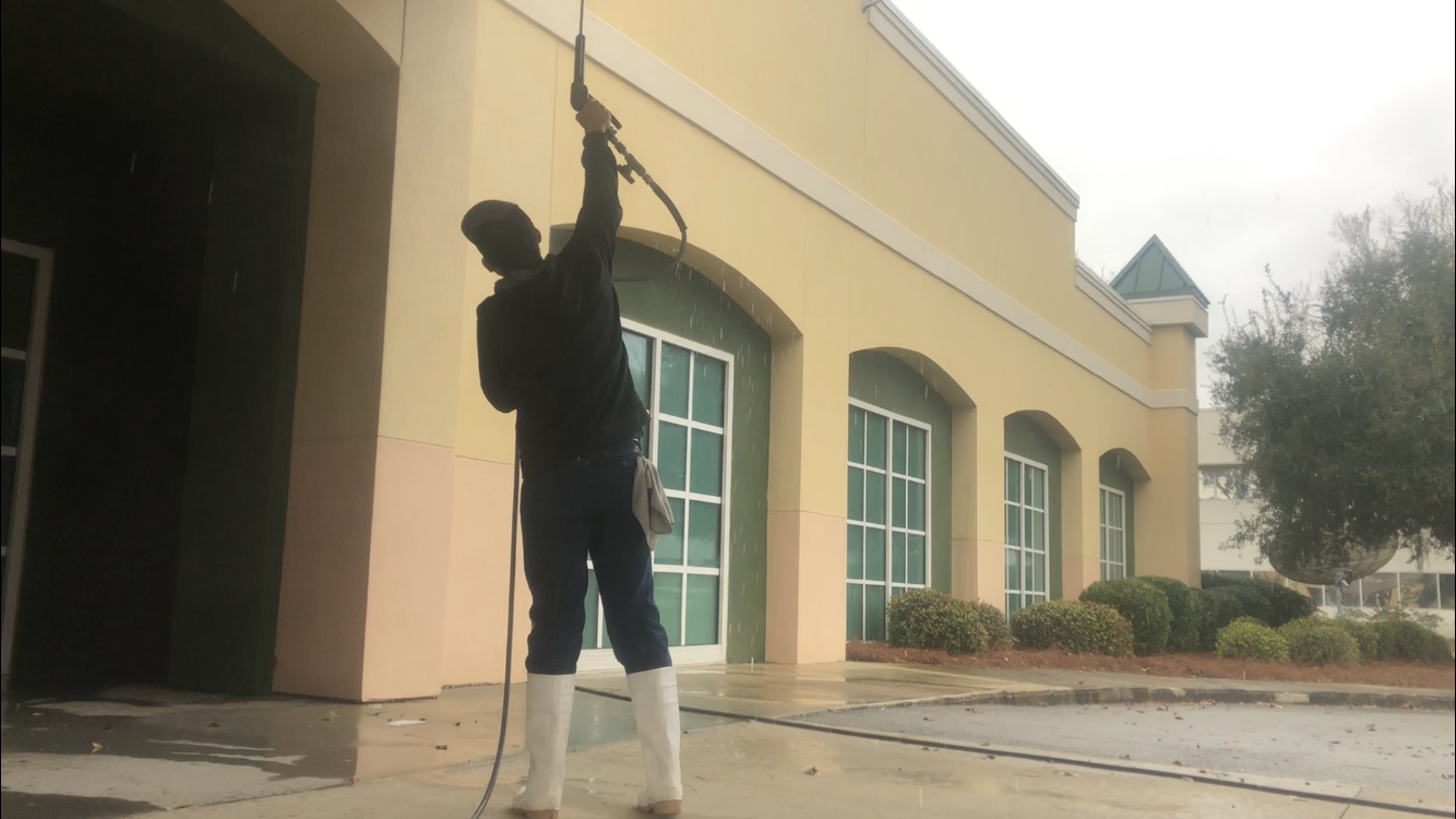 A man is washing the windows of a building